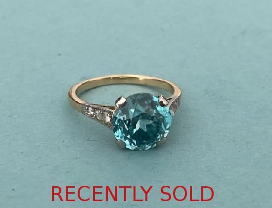 A GORGOUS BLUE ZIRCON AND DIAMOND SOLITAIRE  RING